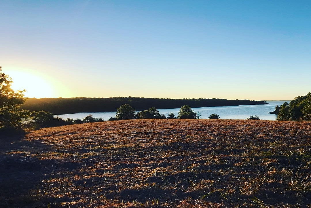 A calm Oklahoma lake framed by green trees