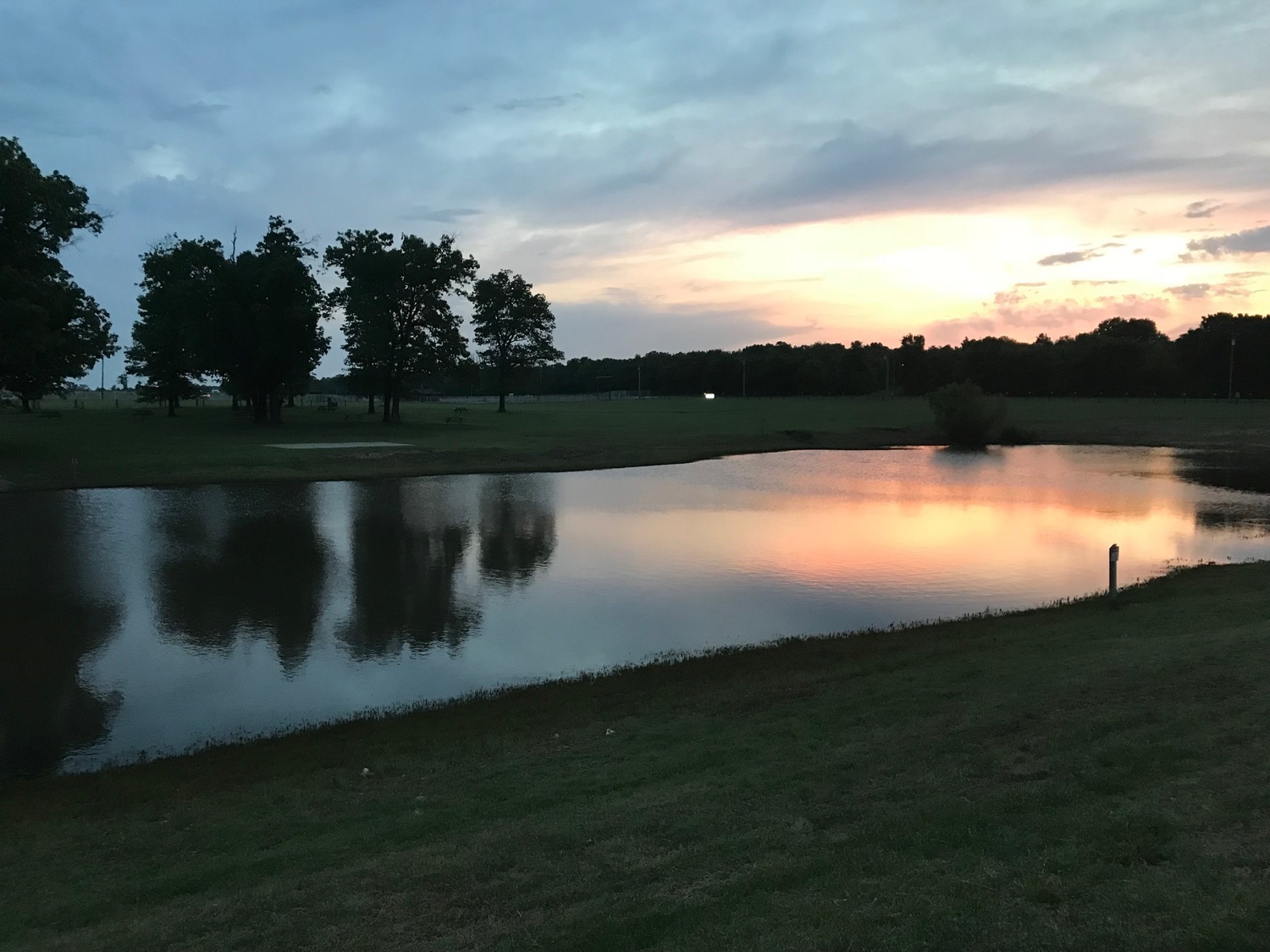 Evening sky reflected on the fishing pond